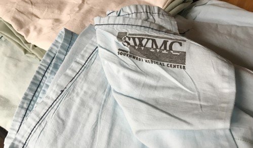 The Southwest Medical Center logo is found among fabric at Grace Lutheran Church. These dyed sheets are part of the fabric used in quilts which benefit many local recipients of the church’s quilting ministry. 